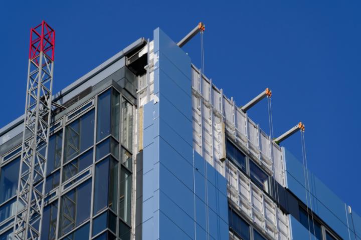 Unsafe cladding being removed from a high-rise residential building