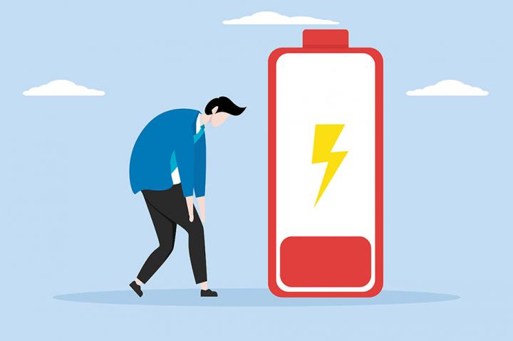 Graphic of a man standing but slumped over, next to a large battery icon that is nearly out of charge