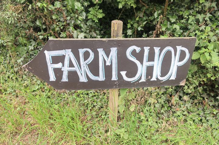 A sign in the ground with the words farm shop written on it