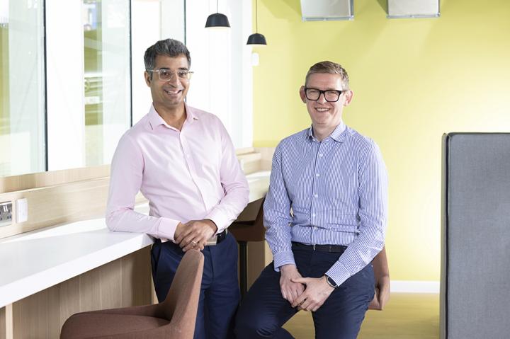 Atif Salim and Anthony Evans, Atif leaning on a bench and Anthony sitting