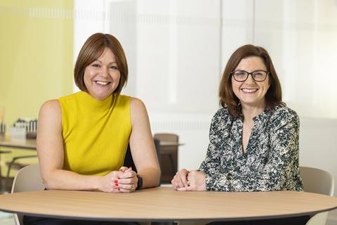 Kelly Jordan and Louise Duffy sitting a table and smiling at the camera