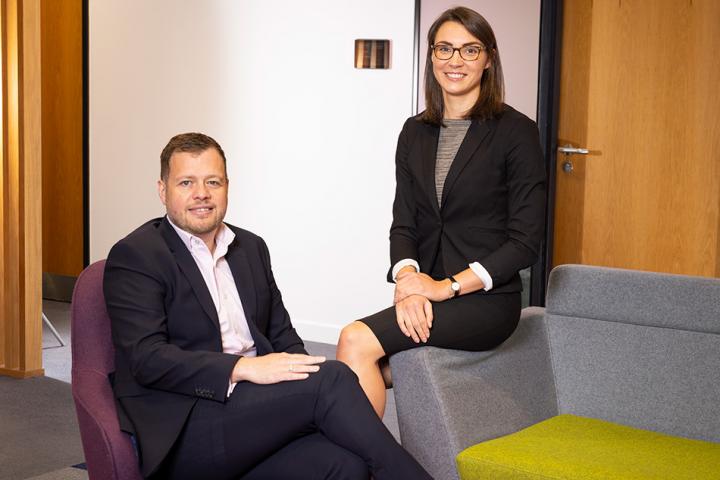 Colin churchward and amy carlton sitting on chairs