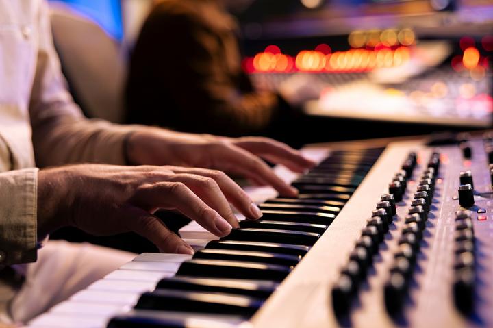 Close up of a man playing a keyboard