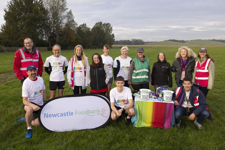 Some of the Muckle team and Newcastle Foodbank standing on a field and smiling at the camera