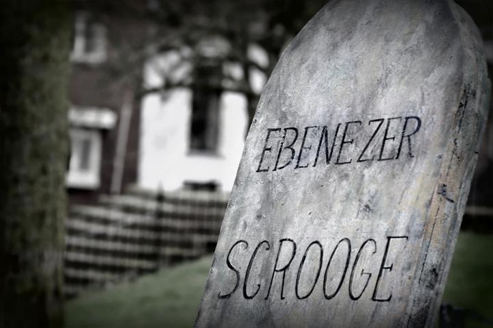 A black and white picture of a headstone saying Ebeneezer Scrooge