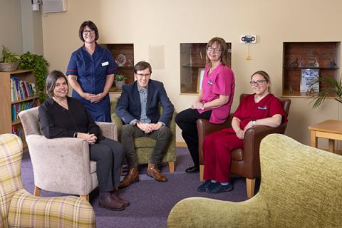 a group of five people sitting in a lounge