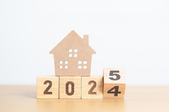 Wooden blocks displaying 2024/5 with a model wooden house on top