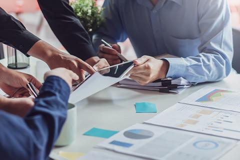 Business meeting between partners, with partners sharing data and insights