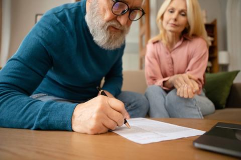 a man and his daughter signing a will