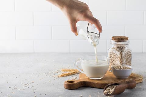 Oat milk being poured into a glass
