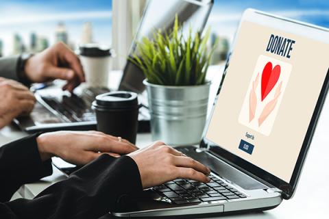 A person sending an online donation to a charity