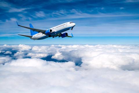 An aeroplane in the sky above the clouds