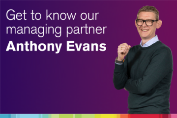 A screen shot from the video, Ant Evans in front of a purple background