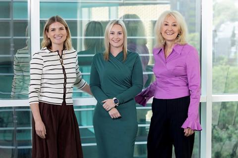 a picture of Leah Duffield, Hayley Bartram and Susan Howe standing in front of a window