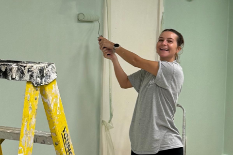 Katharine ronn painting a wall